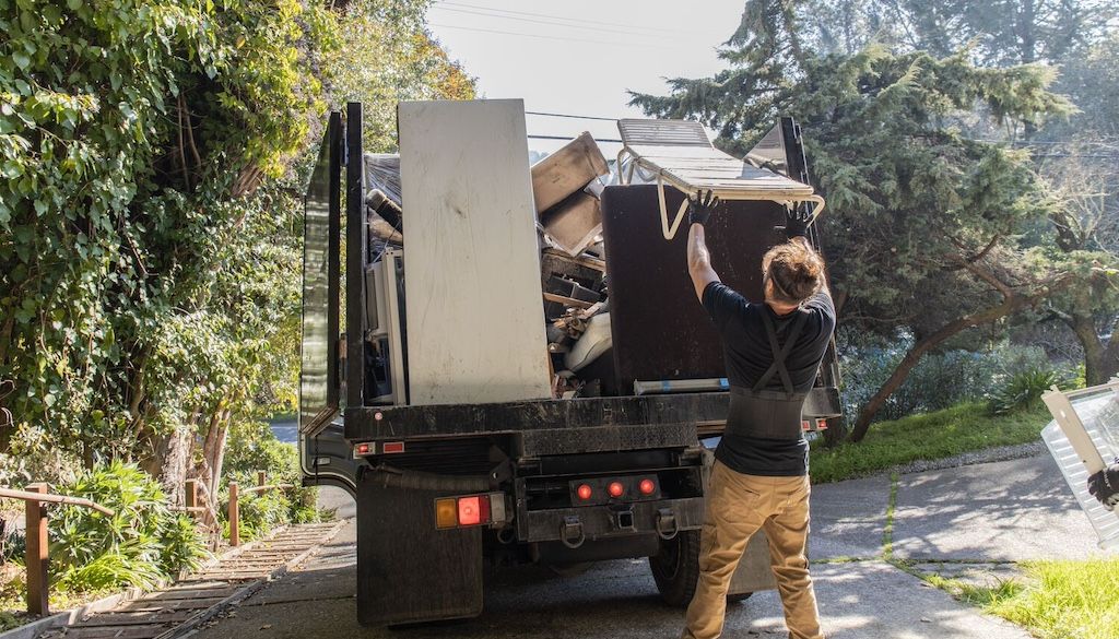 Clutter Cleaners crew loading junk into a truck on a Southeast Michigan job site