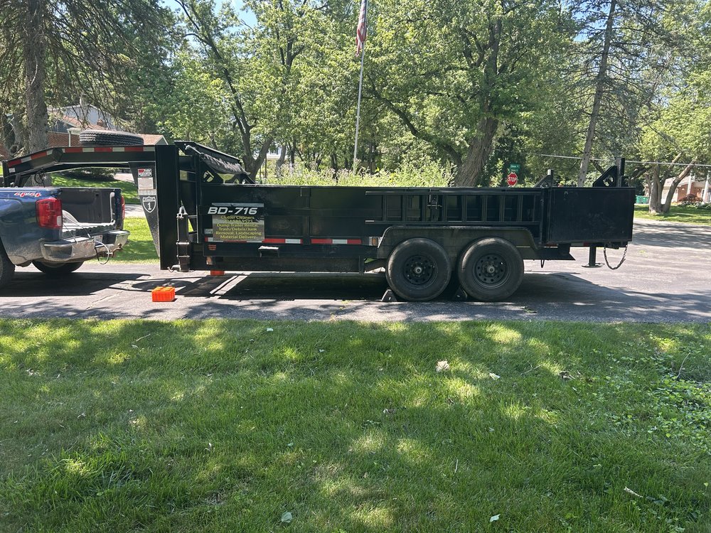 Clutter Cleaners black dump trailer parked on a residential street in Southeast Michigan
